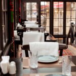 restaurant with red carpet on the floor tables and chairs