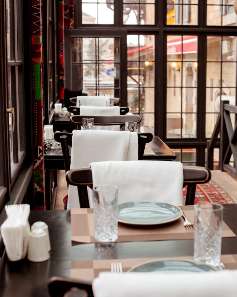 restaurant with red carpet on the floor tables and chairs